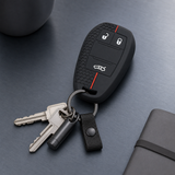 Alfa Romeo silicone key cover with attached keys in a brushed metal lifestyle setting