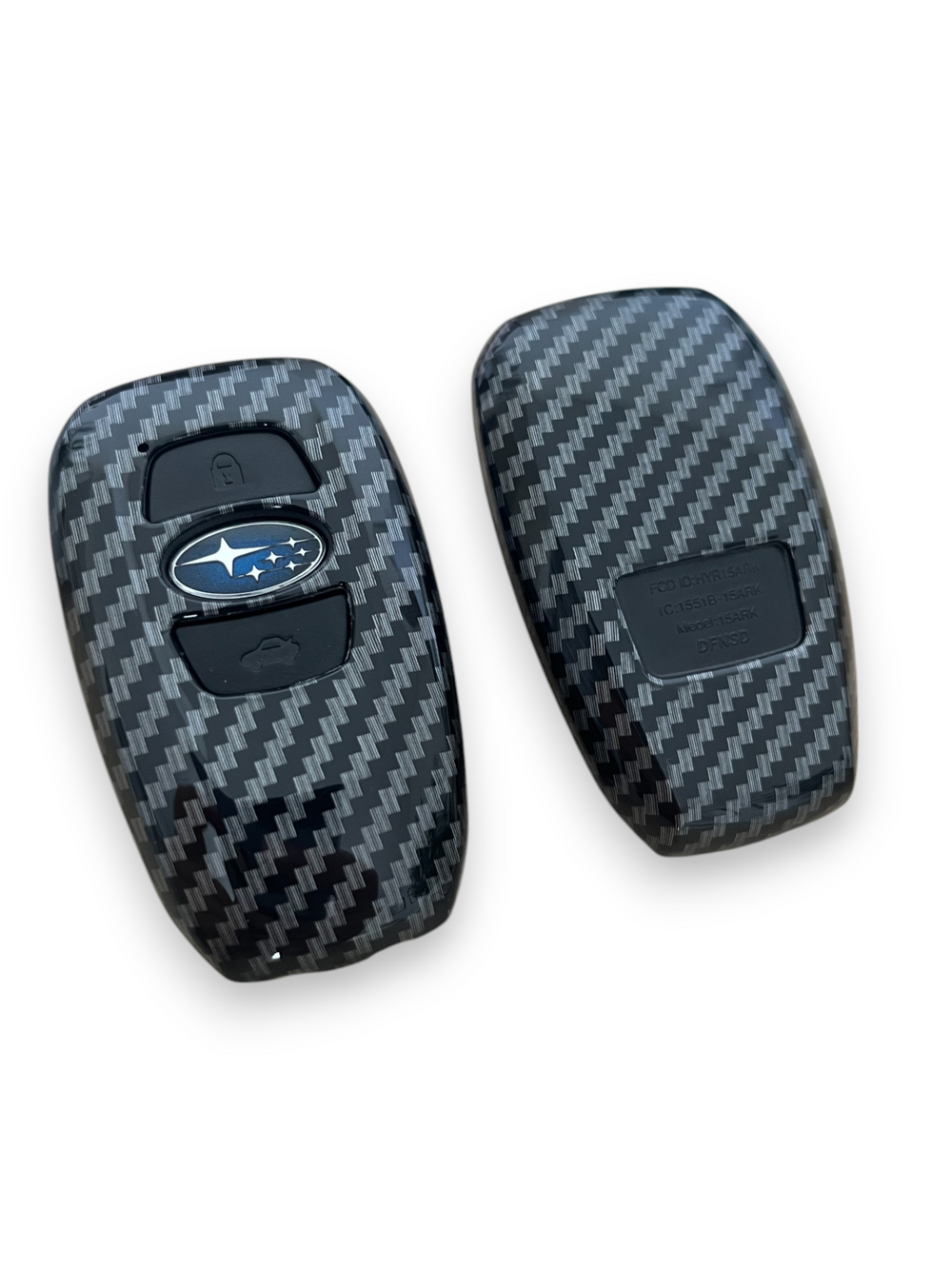 Carbon fibre key covers for Subaru vehicles, showing both the front and back sides with the Subaru logo visible.